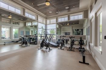 A spacious gym with a variety of exercise equipment.